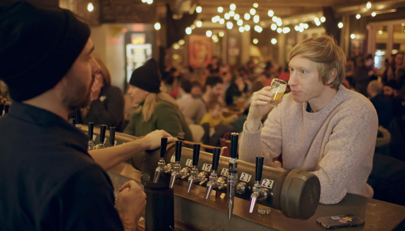 Timothy drinks a craft beer at the microbrewery Griendel