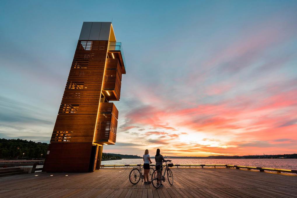 Deux cyclistes contemplent le lever du soleil sur la promenade Samuel-De Champlain, à partir du Quai des Cageux.