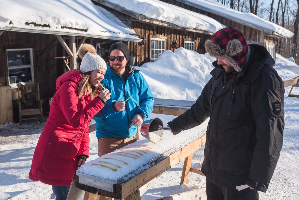 Maple taffy served to a couple at the sugar shack