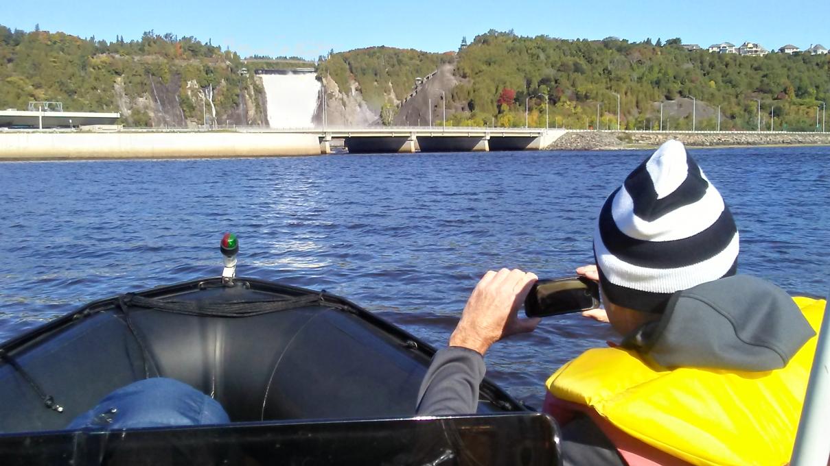 Excursions Maritimes Québec - Visitor aboard a Zodiac with a view of the Montmorency Falls